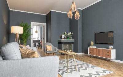 Bright living room with gray walls, a light sofa, a fireplace and wooden pendant lights